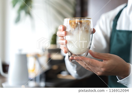 A man serving cafe au lait A man serving cafe au lait 116912094