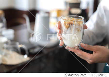 A man serving cafe au lait A man serving cafe au lait 116912095