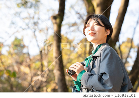 Young lady with bird watching Young lady with bird watching 116912101