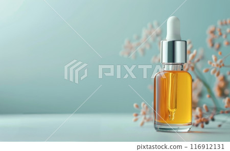 Glass Dropper Bottle of Serum on a Blue Background 116912131