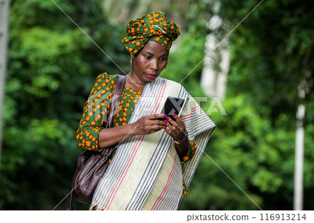 portrait of young african woman with mobile phone. 116913214