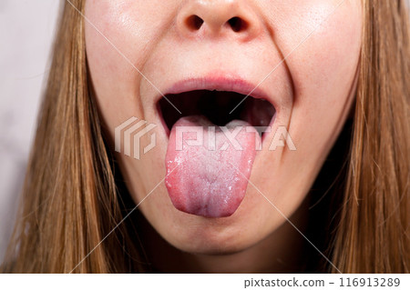 Female tongue. Close-up Of A Woman's Face Showing Her Clean Tongue Female tongue. Close-up Of A Woman's Face Showing Her Clean Tongue 116913289