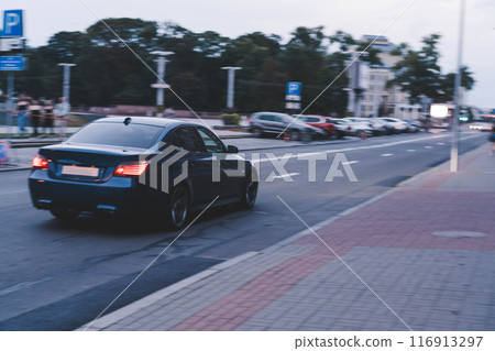 Blurred motion bmw car. Freeze frame of a moving car. BMW 5 series e60 Blurred motion bmw car. Freeze frame of a moving car. BMW 5 series e60 116913297