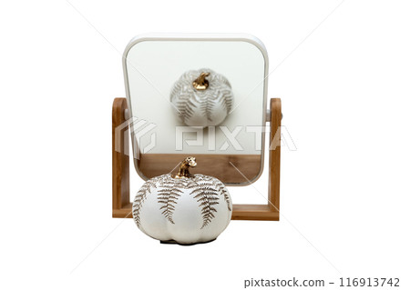 The mirror in which the decorative object is reflected is isolated on a white background. 116913742