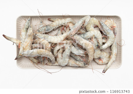 A dish with frozen shrimp isolated on a white background. A dish with frozen shrimp isolated on a white background. 116913743