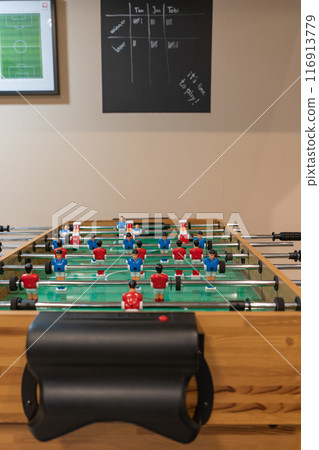 A children's room with a tabletop football game. 116913779
