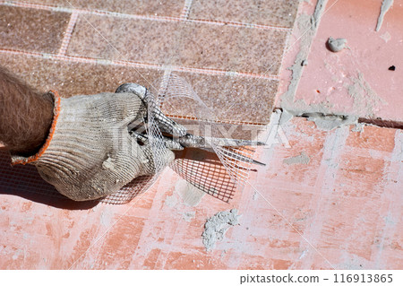 Thin flexible panel of artificial brick made of marble chips is reinforced with plastic mesh, which is cut with scissors during installation. Thin flexible panel of artificial brick made of marble chips is reinforced with plastic mesh, which is cut with scissors during installation. 116913865