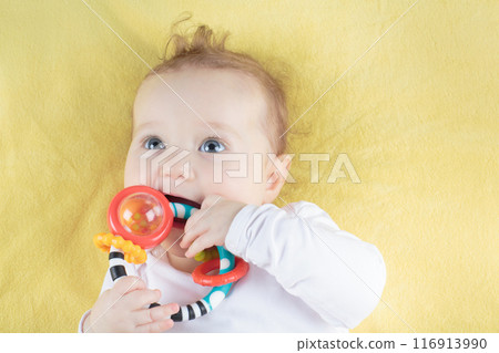 Little baby girl on colorful blanket Little baby girl on colorful blanket 116913990
