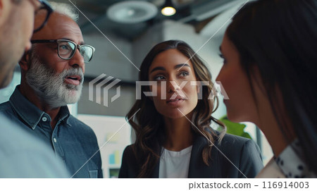 Team of small business professionals collaborating on marketing strategies in modern office 116914003