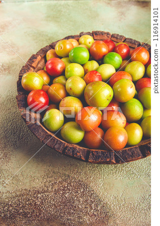 cherry plum tkemali, fruit, plum variety, in a wooden plate, Georgian cuisine, top view, no people, 116914101