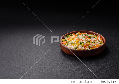Delicious boiled rice with vegetables or risotto with carrots, peas and corn 116915146