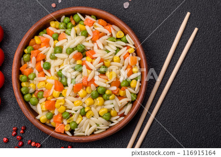 Delicious boiled rice with vegetables or risotto with carrots, peas and corn 116915164