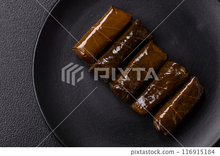 Delicious dolma in the form of rice and meat wrapped in grape leaves Delicious dolma in the form of rice and meat wrapped in grape leaves 116915184