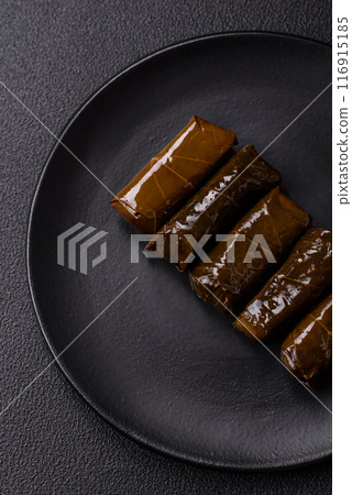 Delicious dolma in the form of rice and meat wrapped in grape leaves Delicious dolma in the form of rice and meat wrapped in grape leaves 116915185