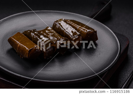 Delicious dolma in the form of rice and meat wrapped in grape leaves Delicious dolma in the form of rice and meat wrapped in grape leaves 116915186