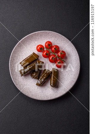 Delicious dolma in the form of rice and meat wrapped in grape leaves Delicious dolma in the form of rice and meat wrapped in grape leaves 116915197