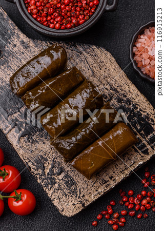 Delicious dolma in the form of rice and meat wrapped in grape leaves Delicious dolma in the form of rice and meat wrapped in grape leaves 116915213