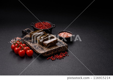 Delicious dolma in the form of rice and meat wrapped in grape leaves Delicious dolma in the form of rice and meat wrapped in grape leaves 116915214