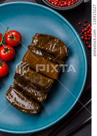 Delicious dolma in the form of rice and meat wrapped in grape leaves 116915227