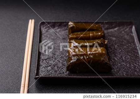 Delicious dolma in the form of rice and meat wrapped in grape leaves 116915234