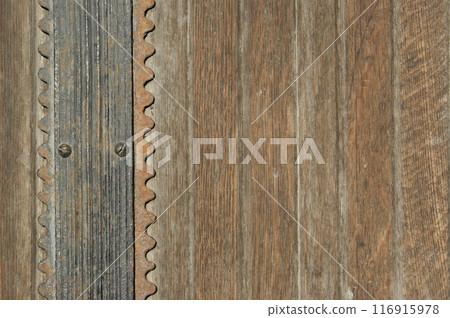 Antique doors with metal elements. Fragment of an old door 116915978