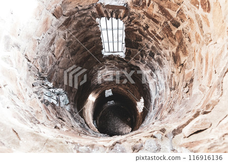 A deep view into the interior of the Krasno lookout tower, showcasing the circular stone architecture and descending perspective. 116916136