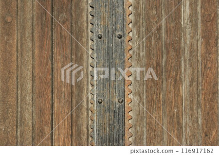 Fragment of an old door. Antique doors with metal elements Fragment of an old door. Antique doors with metal elements 116917162