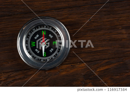 compass on wooden background compass on wooden background 116917384