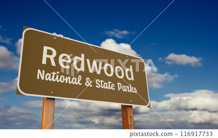 Redwood National and State Parks (California) Road Sign Against Blue Sky and Clouds. 116917733