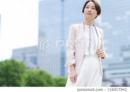 Middle-aged business woman working in an office district 116917942