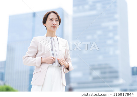 Middle-aged business woman working in an office district 116917944