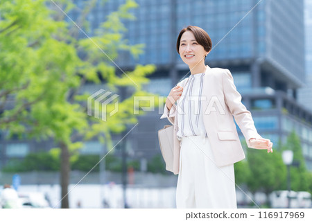 Middle-aged business woman working in an office district 116917969