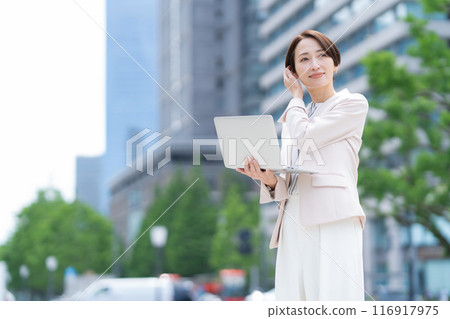 Middle-aged business woman working in an office district Middle-aged business woman working in an office district 116917975