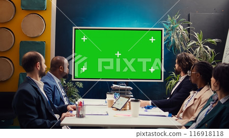 Startup team watching an ad campaign video on greenscreen display, examining the final promotional product to ensure sales growth. PR specialists collaborating on enterprise development. Camera B. 116918118