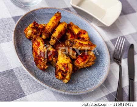 Appetizing baked chicken wings 116918432