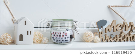Original Advent Calendar made of glass jar and sweet chocolate candies Christmas concept. Countdown till winter holidays. Handmade advent calendar. Step by step DIY Original Advent Calendar made of glass jar and sweet chocolate candies Christmas concept. Countdown till winter holidays. Handmade advent calendar. Step by step DIY 116919430