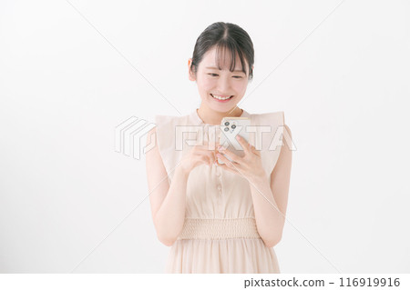 Young woman looking at a smartphone Young woman looking at a smartphone 116919916