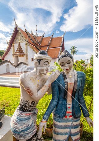 The sculpture of Lanna peoples in front of beautiful viharn in Wat Phumin the most attractive temple in the town of Nan. 116919949