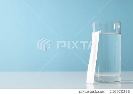 Collagen in a white stick with a glass of water 116920226