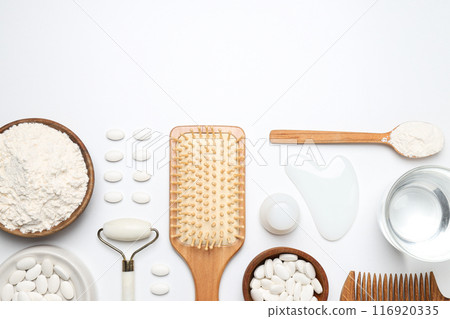 Collagen in powder and tablets with a wooden comb 116920335