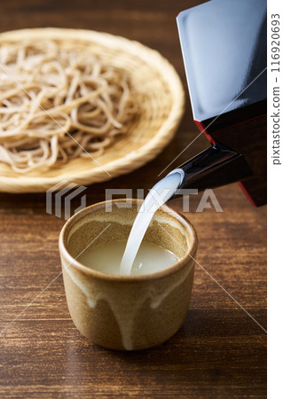 Pour the soba soup into a teacup Pour the soba soup into a teacup 116920693