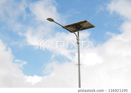 Blue Cloudy Sky and Street Lamp Minimalist Scene Blue Cloudy Sky and Street Lamp Minimalist Scene 116921295