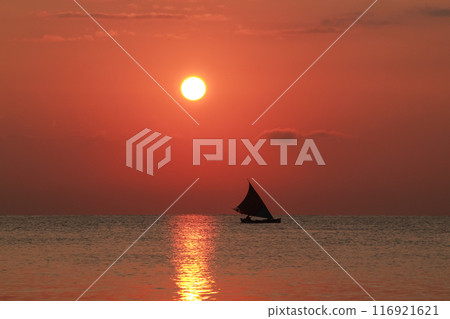 Beautiful sunrise on the sea and silhouette of a fishing boat 116921621