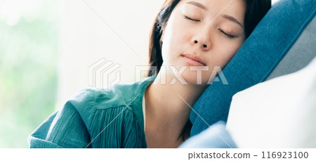 A woman relaxing on the sofa A woman relaxing on the sofa 116923100