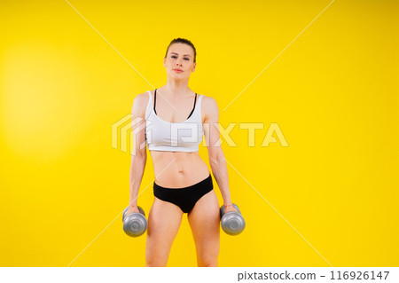 Back view of female model posing in studio and demonstrating comfortable activewear. Back view of female model posing in studio and demonstrating comfortable activewear. 116926147