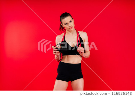 Athletic female performs exercises using a resistance band. Strength and motivation Athletic female performs exercises using a resistance band. Strength and motivation 116926148