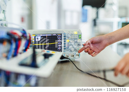 Working on circuit board, building robot in after-school robotics club. Children learning robotics in Elementary school. Working on circuit board, building robot in after-school robotics club. Children learning robotics in Elementary school. 116927158
