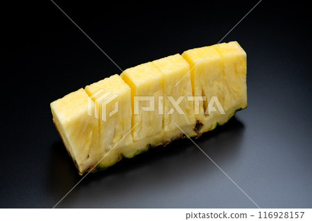 Cut pineapple on a black background Cut pineapple on a black background 116928157