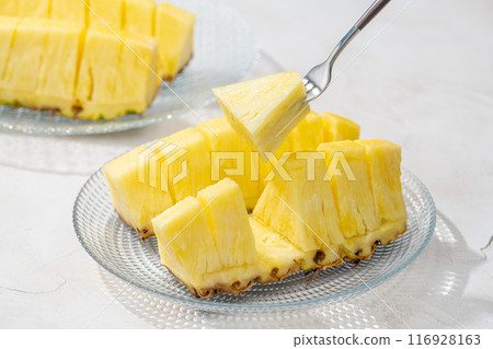 Eat cut pineapple with a fork Eat cut pineapple with a fork 116928163
