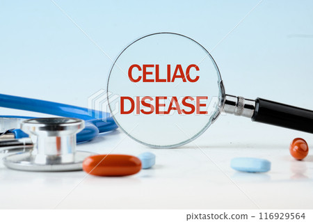 Gluten Free Celiac Disease Concept. Words CELIAC DISEASE through a magnifying glass on a blue background. Concept photo 116929564